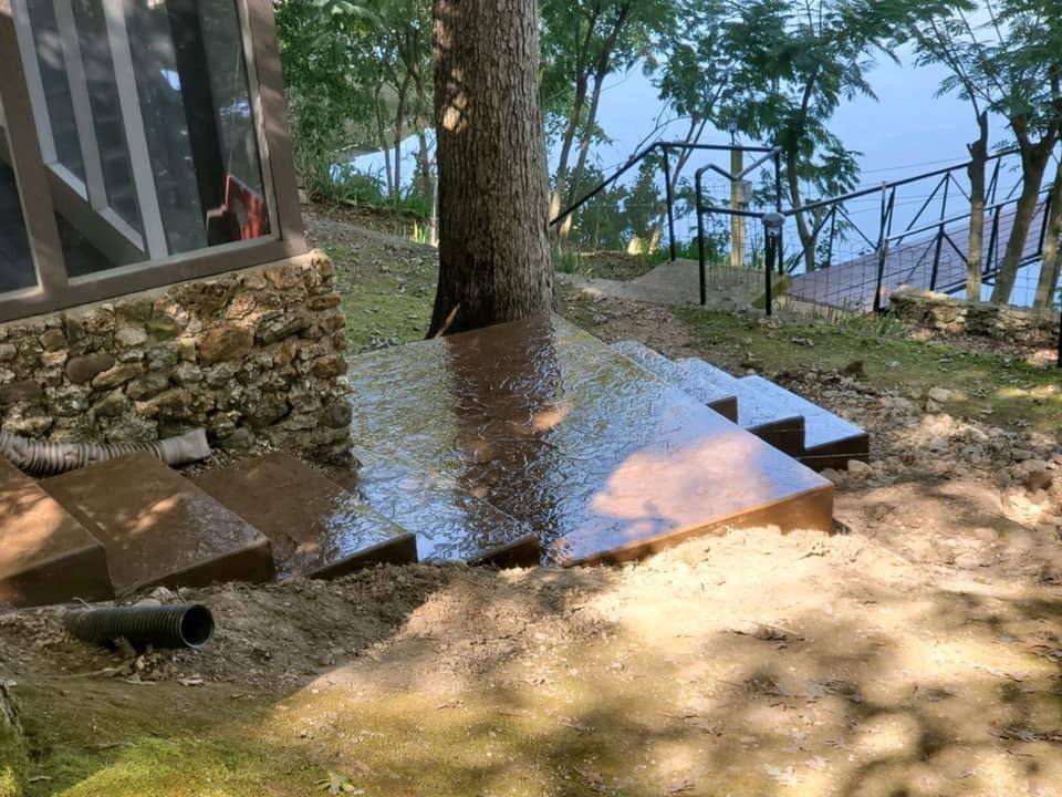 Brown stamped and sealed concrete steps and pad at the water's edge