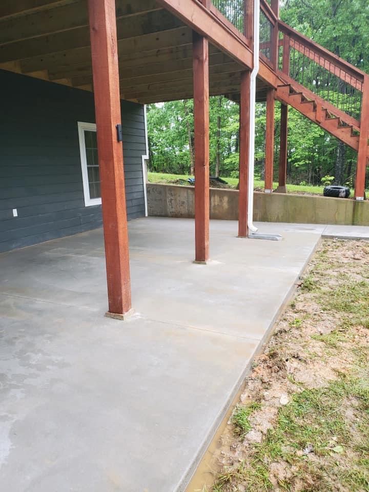 Smooth concrete patio poured under a raised deck